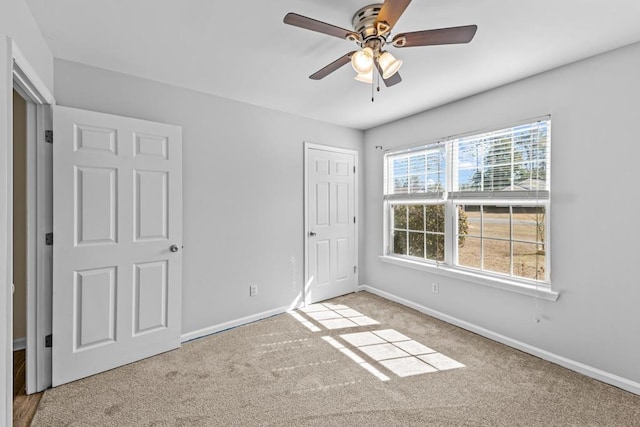 unfurnished bedroom with ceiling fan and light carpet