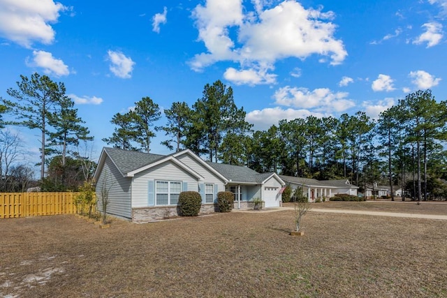 single story home featuring a garage and a front yard