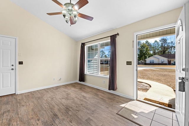 doorway featuring hardwood / wood-style flooring, ceiling fan, and lofted ceiling