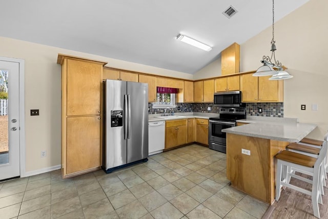 kitchen with sink, appliances with stainless steel finishes, backsplash, decorative light fixtures, and kitchen peninsula