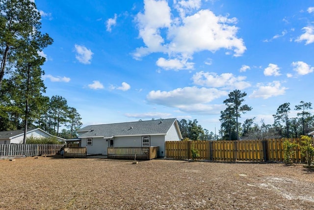 rear view of house featuring a wooden deck