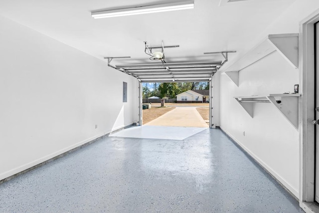 garage with a garage door opener and electric panel