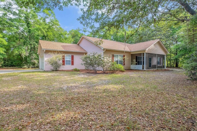 55 Hopkins Landing Rd, Quincy, FL 32351 - view of front facade with a sunroom, a front lawn, and a shingled roof