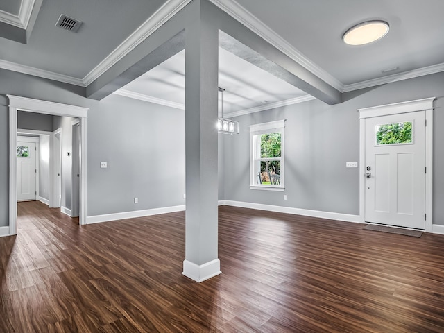 foyer entrance with ornamental molding, dark wood-type flooring, and beam ceiling