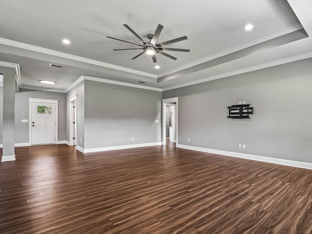 unfurnished living room with ceiling fan, a raised ceiling, dark hardwood / wood-style flooring, and ornamental molding