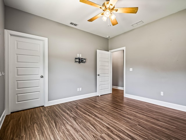 unfurnished bedroom featuring ceiling fan and dark hardwood / wood-style floors