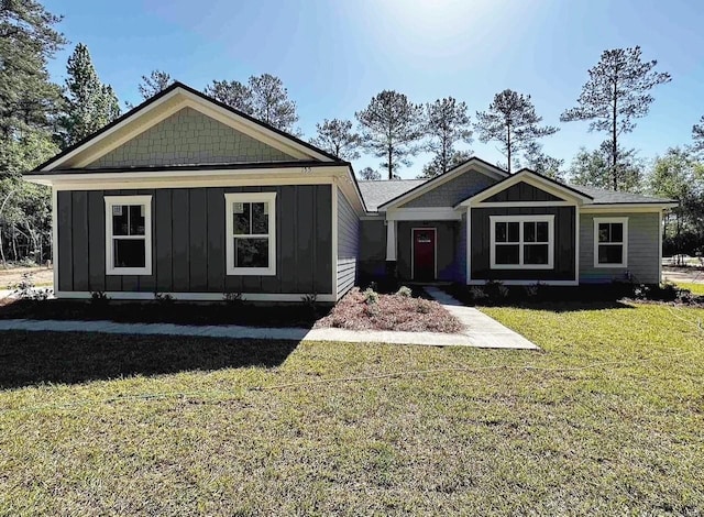 craftsman-style home with board and batten siding and a front lawn