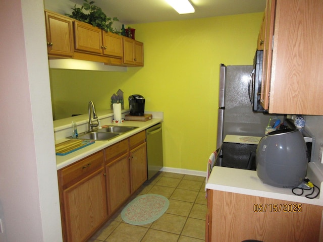2738 W Tharpe St Unit 2101, Tallahassee, FL 32303 - kitchen featuring stainless steel appliances, a sink, light countertops, light tile patterned floors, and brown cabinetry