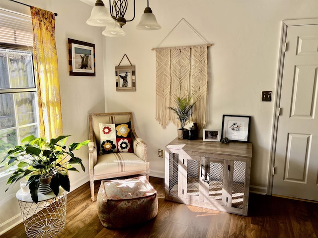 sitting room with an inviting chandelier and wood-type flooring