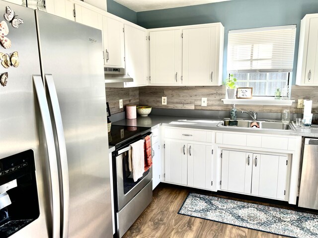 kitchen with sink, dark wood-type flooring, appliances with stainless steel finishes, backsplash, and white cabinets