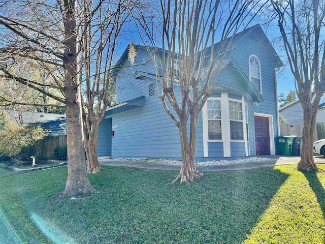 view of home's exterior featuring a garage and a lawn