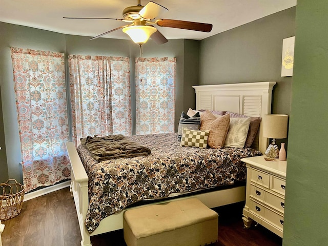 bedroom with dark hardwood / wood-style floors and ceiling fan