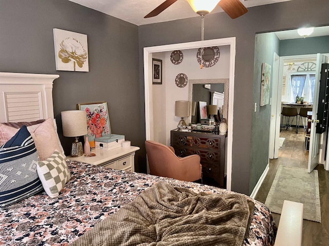 bedroom with wood-type flooring and ceiling fan