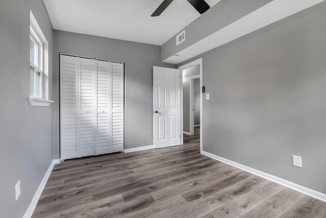 1722 Eisenhower St, Tallahassee, FL 32310 - unfurnished bedroom with baseboards, wood finished floors, a closet, and ceiling fan