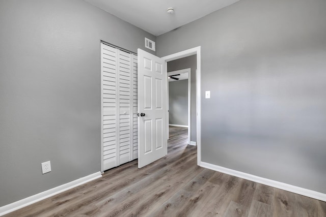 1722 Eisenhower St, Tallahassee, FL 32310 - unfurnished bedroom with wood finished floors, baseboards, and a closet