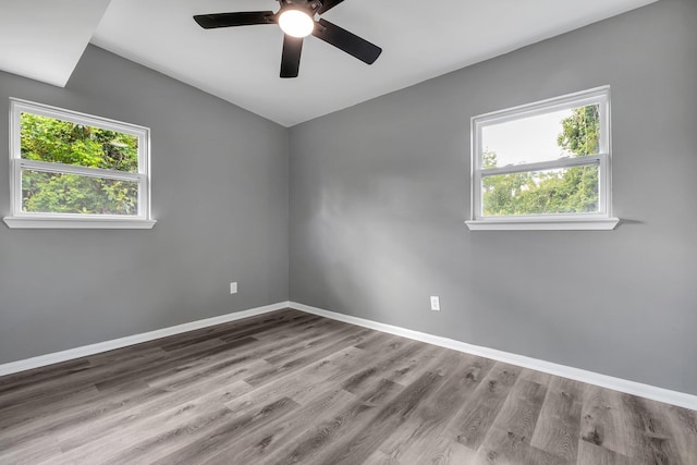 1722 Eisenhower St, Tallahassee, FL 32310 - empty room featuring plenty of natural light, a ceiling fan, wood finished floors, baseboards, and vaulted ceiling