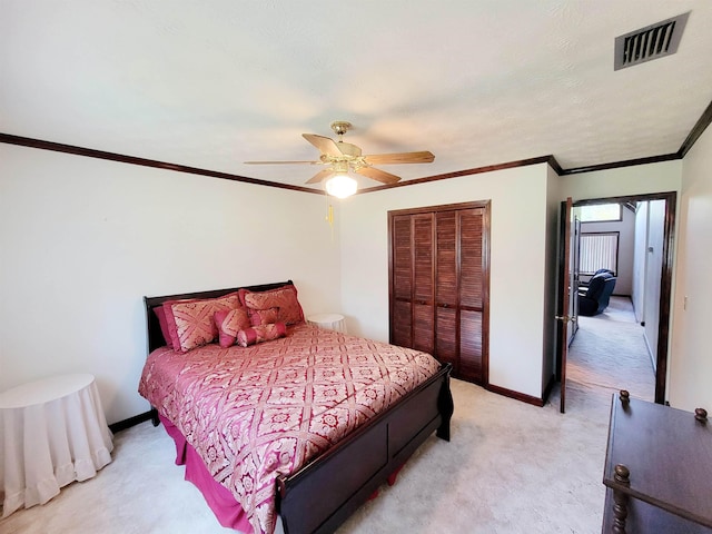 2917 Glover Carlton Rd, Perry, FL 32348 - bedroom featuring light carpet, a closet, baseboards, a ceiling fan, and ornamental molding