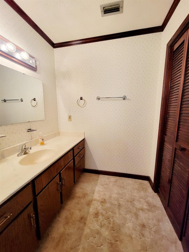 2917 Glover Carlton Rd, Perry, FL 32348 - bathroom with crown molding, vanity, baseboards, and wallpapered walls