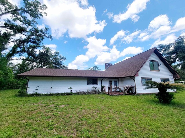 2917 Glover Carlton Rd, Perry, FL 32348 - back of property with french doors, a yard, and a chimney