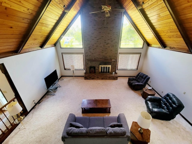 2917 Glover Carlton Rd, Perry, FL 32348 - carpeted living area featuring wood ceiling with exposed beams, healthy amount of natural light, a brick fireplace, and high vaulted ceiling