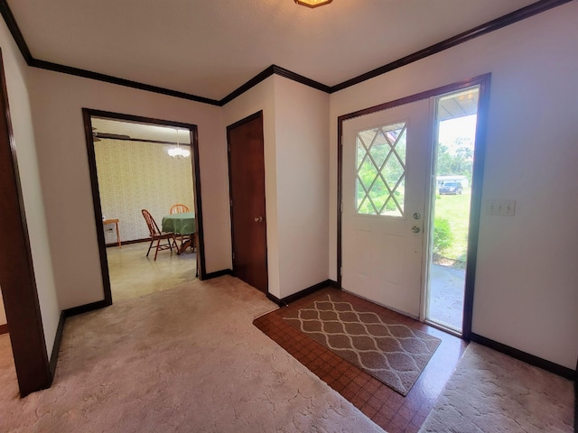 2917 Glover Carlton Rd, Perry, FL 32348 - foyer with baseboards, crown molding, light colored carpet, and a chandelier
