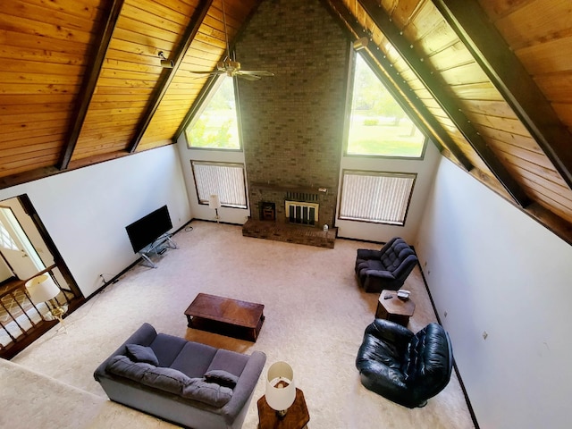 2917 Glover Carlton Rd, Perry, FL 32348 - living room with wood ceiling with exposed beams, a brick fireplace, plenty of natural light, high vaulted ceiling, and carpet floors