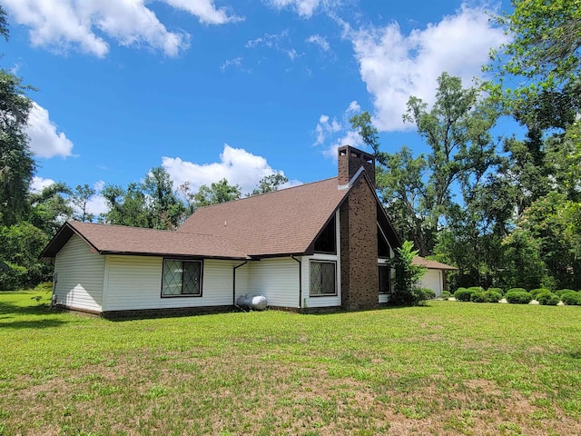 2917 Glover Carlton Rd, Perry, FL 32348 - view of front of property with a front yard, a chimney, and a shingled roof