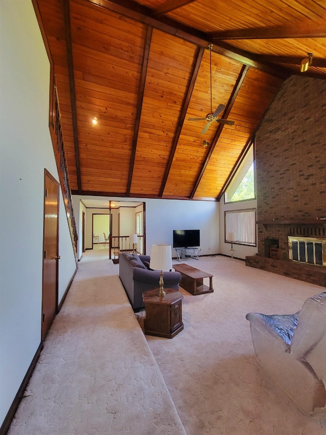 2917 Glover Carlton Rd, Perry, FL 32348 - carpeted living area featuring wooden ceiling with exposed beams, a brick fireplace, high vaulted ceiling, and baseboards