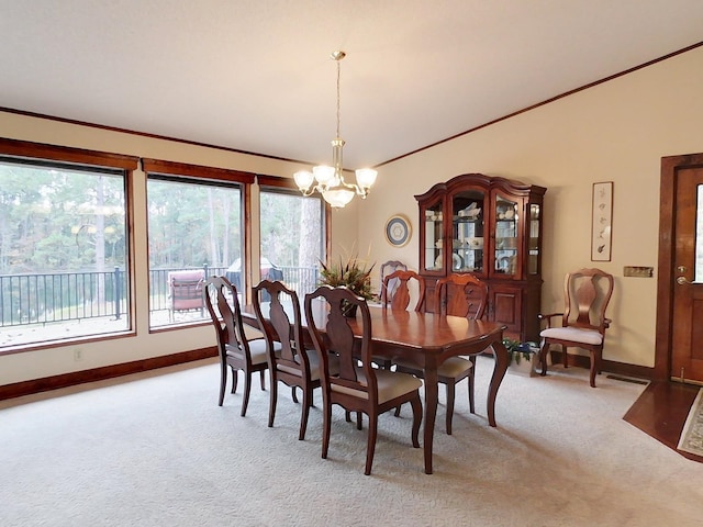 carpeted dining space with a chandelier