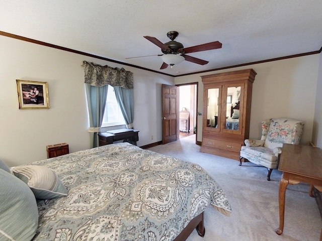 carpeted bedroom with a textured ceiling, ceiling fan, and ornamental molding