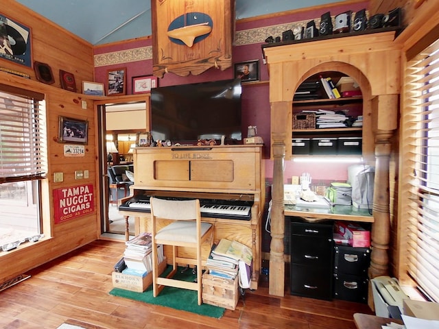 office space with hardwood / wood-style flooring and wooden walls