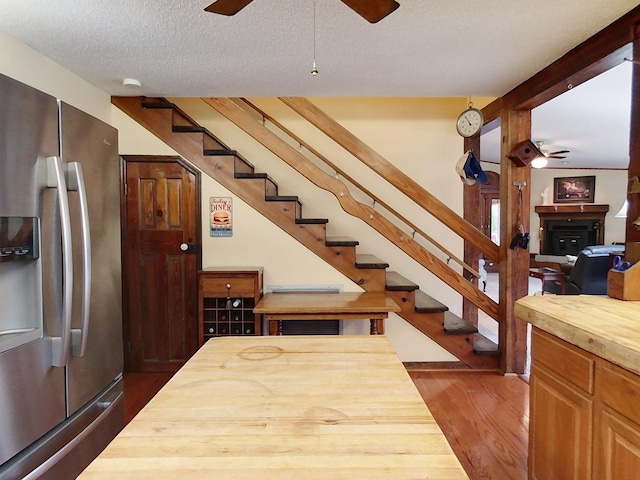 interior space with hardwood / wood-style floors, a textured ceiling, and ceiling fan