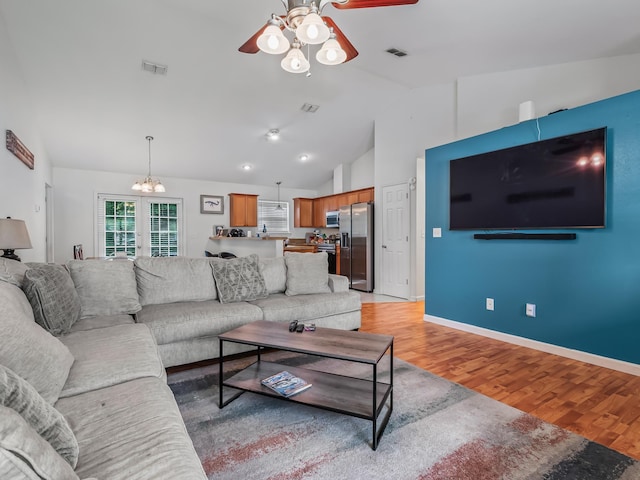 33 Paulette Dr, Crawfordville, FL 32327 - living room featuring ceiling fan, vaulted ceiling, light wood finished floors, and a chandelier