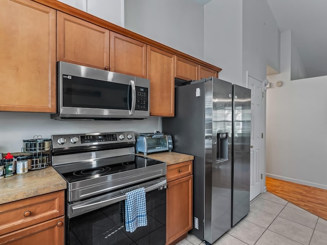 33 Paulette Dr, Crawfordville, FL 32327 - kitchen featuring appliances with stainless steel finishes, brown cabinetry, and light countertops