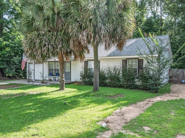 33 Paulette Dr, Crawfordville, FL 32327 - view of property hidden behind natural elements featuring roof with shingles, an attached garage, and driveway