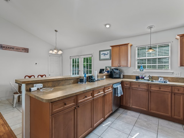 33 Paulette Dr, Crawfordville, FL 32327 - kitchen featuring stainless steel dishwasher, a peninsula, lofted ceiling, pendant lighting, and brown cabinetry