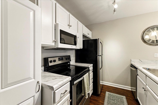 2738 W Tharpe St Unit 2302, Tallahassee, FL 32303 - kitchen featuring appliances with stainless steel finishes, dark wood-style flooring, white cabinetry, and light countertops