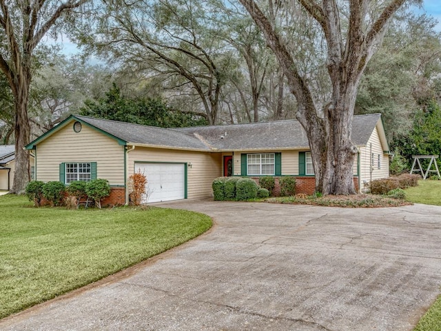 ranch-style home with a garage and a front lawn