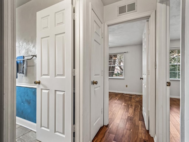 corridor featuring hardwood / wood-style floors