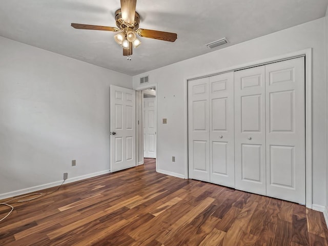 unfurnished bedroom with ceiling fan, dark hardwood / wood-style floors, and a closet