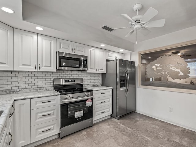 kitchen featuring tasteful backsplash, ceiling fan, stainless steel appliances, and white cabinets