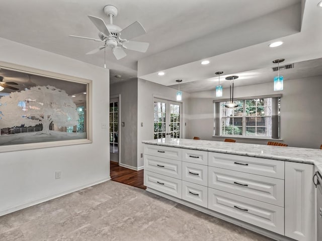 kitchen featuring pendant lighting, white cabinets, ceiling fan, light stone countertops, and french doors