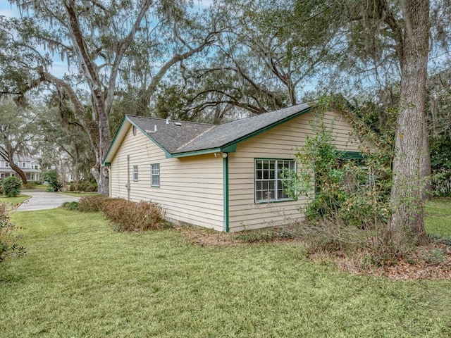 view of side of home with a yard