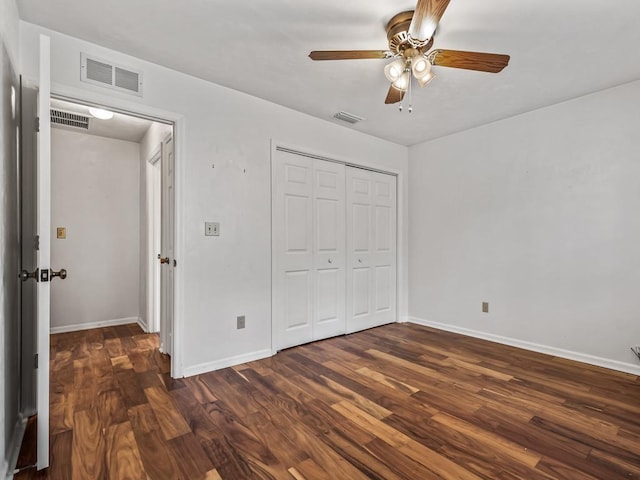 unfurnished bedroom with ceiling fan, dark hardwood / wood-style flooring, and a closet