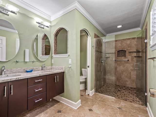 bathroom featuring crown molding, toilet, and a shower with shower door