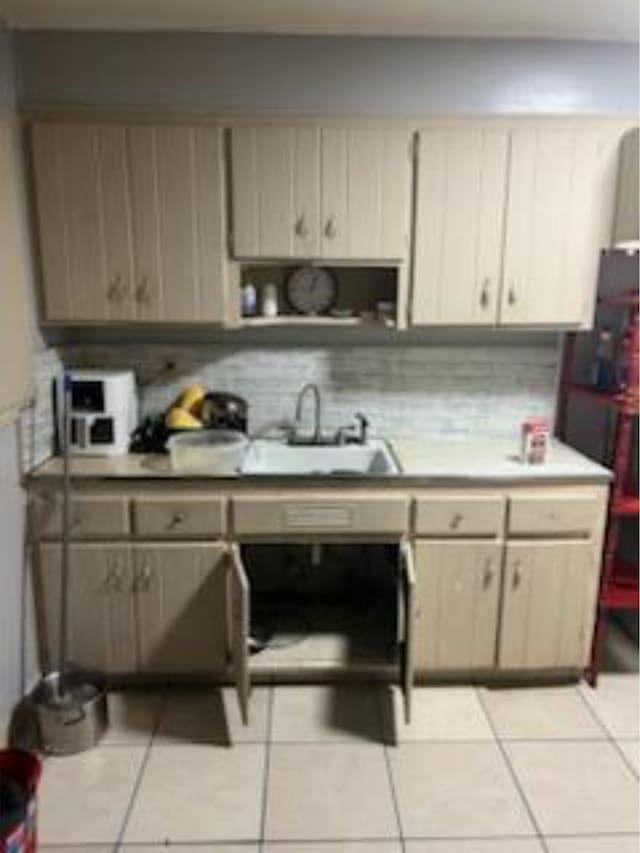 212 Susan St, Perry, FL 32348 - kitchen with a sink, light tile patterned flooring, tasteful backsplash, light countertops, and freestanding refrigerator