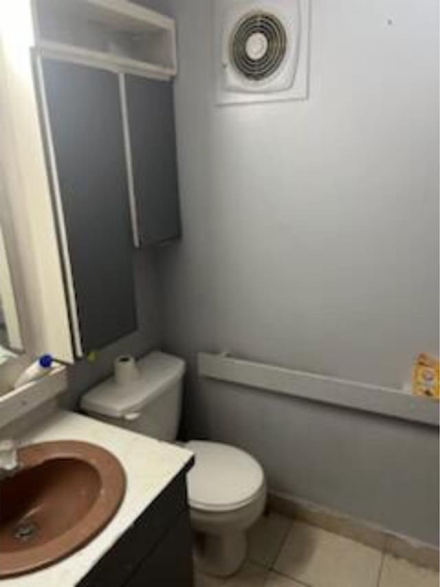 212 Susan St, Perry, FL 32348 - half bath with vanity, toilet, and tile patterned floors