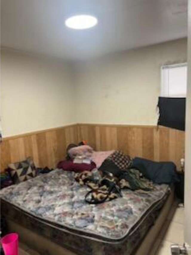 212 Susan St, Perry, FL 32348 - bedroom with a wainscoted wall and wood walls