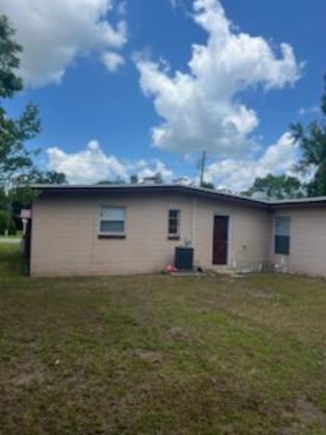 212 Susan St, Perry, FL 32348 - rear view of property featuring a yard and central AC