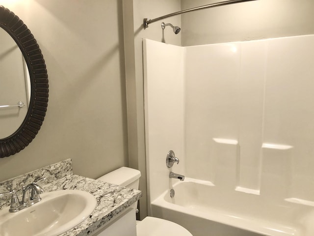 full bathroom featuring shower / bath combination, vanity, and toilet